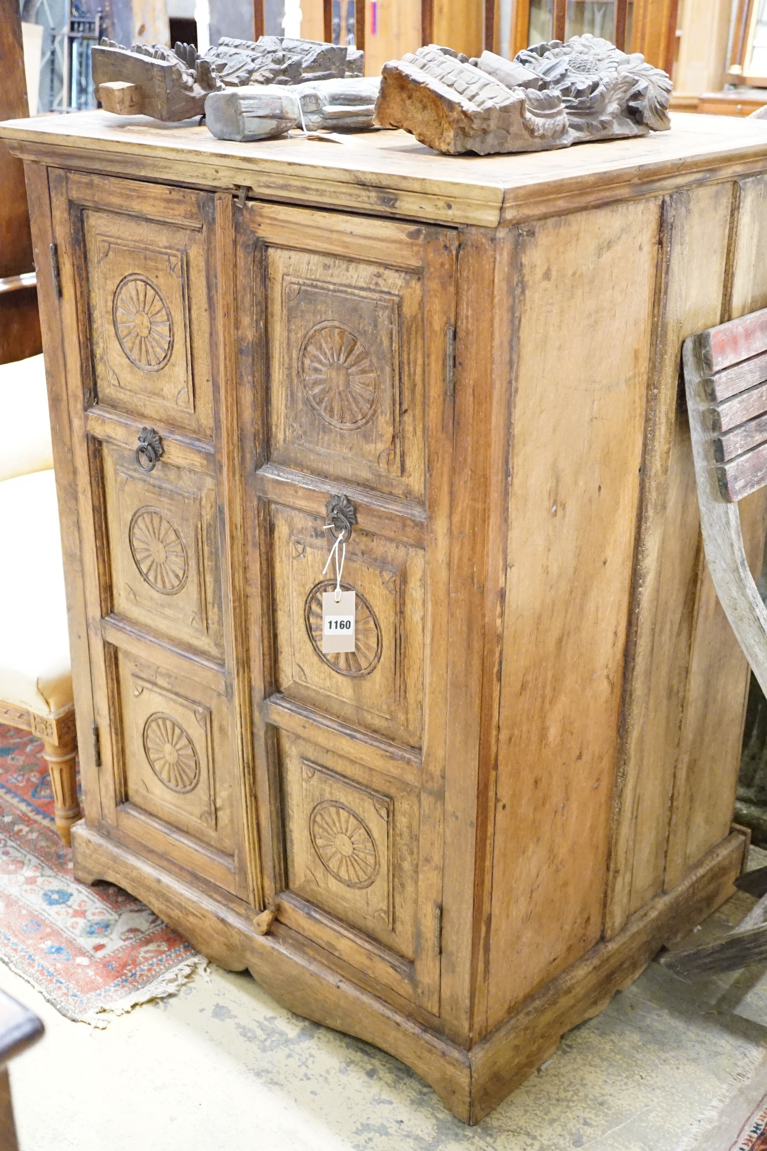 An Indian carved hardwood cupboard, width 77cm, height 107cm
